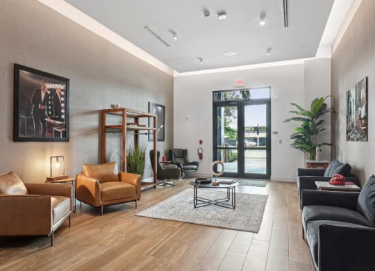 a living room with leather furniture and a door to a patio