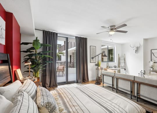 a bedroom with a bed and a ceiling fan