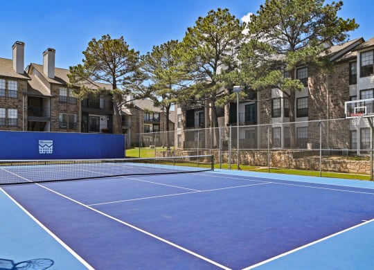 take a swing at one of the tennis courts at the enclave at woodbridge apartments in sugar