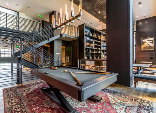 Billiards table sitting inside of a decorative game room at The Case Building in Dallas, TX