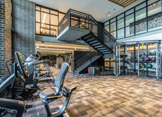 Large gym with a variety of workout equipment at The Case Building in Dallas, TX