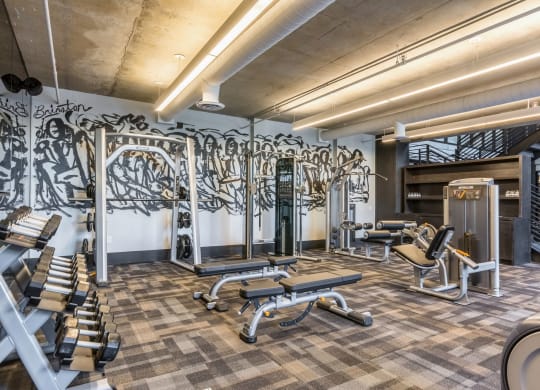 Spacious gym with multiple exercise equipment pieces at The Case Building in Dallas, TX
