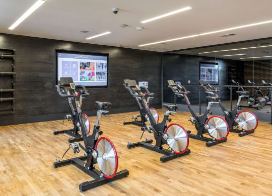 Flex fitness spinning class equipment in well lit space at The Case Building in Dallas, TX