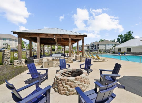 Firepit with blue chairs at Capital Grand Apartments in Tallahassee, FL
