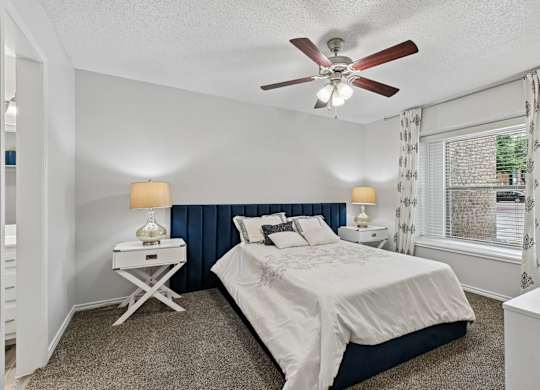 Model unit bedroom at Chisholm Place in Plano, TX