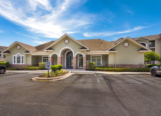 Exterior view of the clubhouse with inviting architecture at Angel Landing apartments in Pensacola, FL