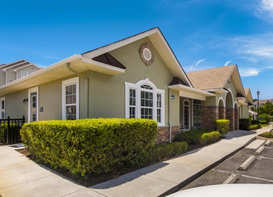 Well-maintained clubhouse exterior surrounded by lush landscaping at Angel Landing apartments in Pensacola, FL