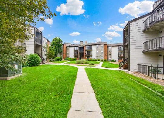 Beautiful community walkways between apartment buildings at Greensview Apartments in Aurora, CO