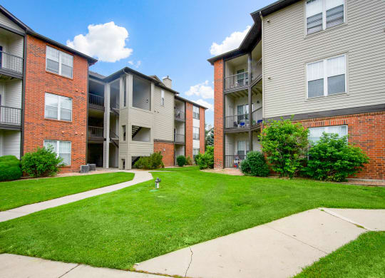 View of our community and apartment buildings surrounded by our beautifully maintained grounds at Greensview Apartments in Aurora, CO