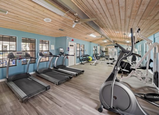 a gym with treadmills and other exercise equipment