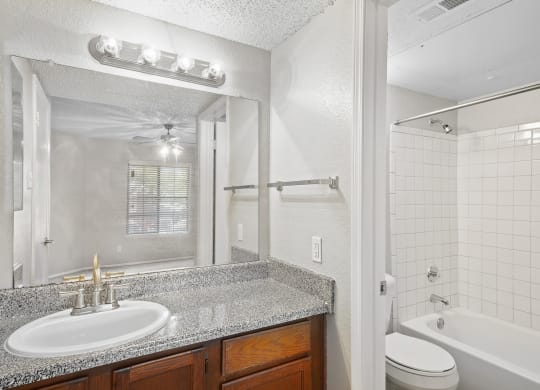 a bathroom with a sink toilet and tub