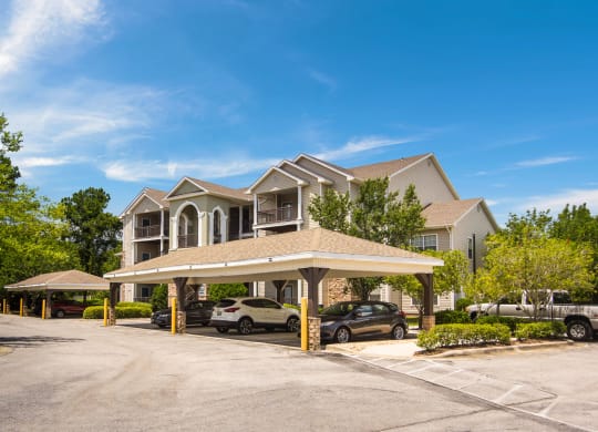 Covered parking spaces by the apartment buildings at Angel Landing Apartment Homes in Pensacola, FL