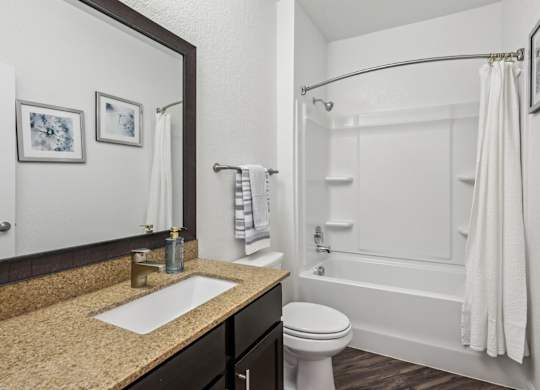 B3 bathroom with a sink, toilet, and bathtub at Creekside on Parmer Lane Apartments in Austin, TX