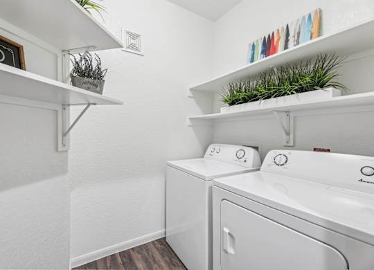 B3 laundry room with a  full size washer and dryer at Creekside on Parmer Lane Apartments in Austin, TX