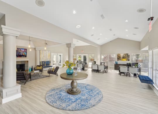 Interior of leasing office  with vaulted ceiling, office desks, and seating at Davenport Apartments in Dallas, TX