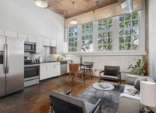 Futura Lofts living area with a kitchen and large windows