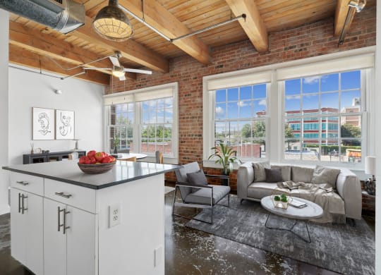 Murray Lofts Kitchen island and living room with large windows. Deep Ellum Lofts in Dallas, TX