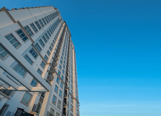 the tall apartment building with a blue sky in the background of Dominion Post Oak  in Houston, TX