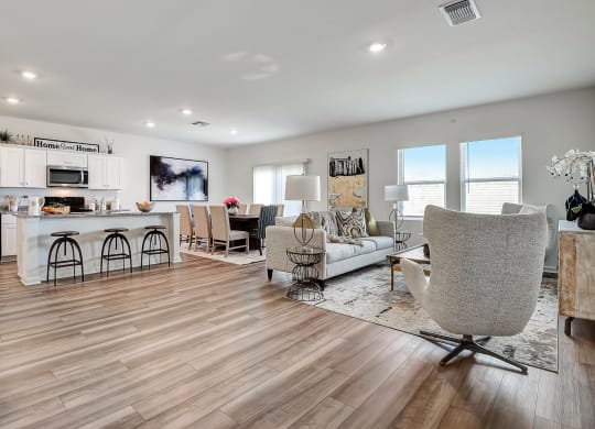 a spacious living room with a kitchen and a dining room