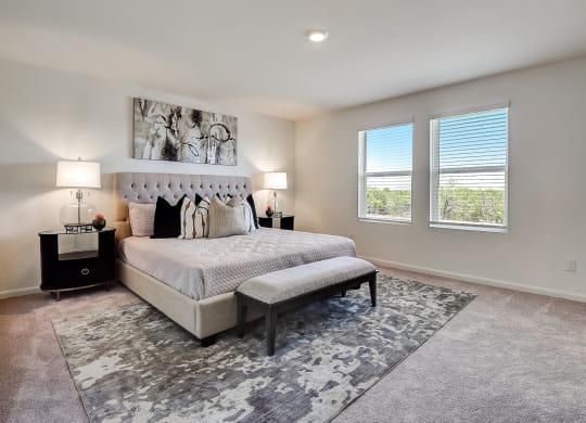 master bedroom with a bed and two windows