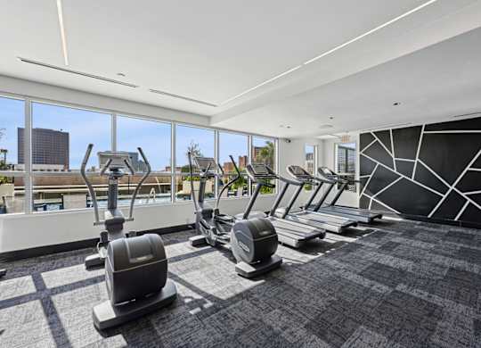 Our gym with treadmills and elliptical machines at Dominion Post Oak apartments in Houston, TX