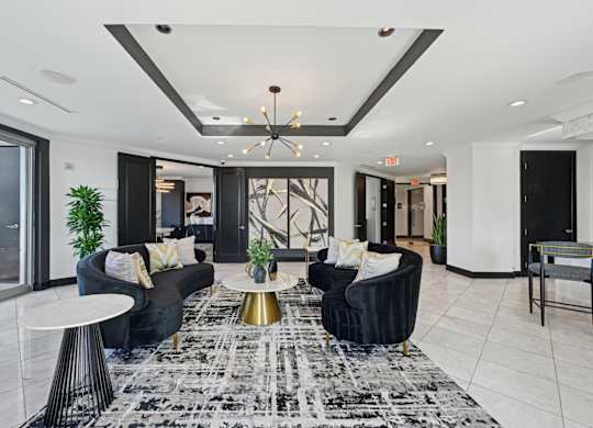 Resident lounge with two black couches at Dominion Post Oak apartments in Houston, TX