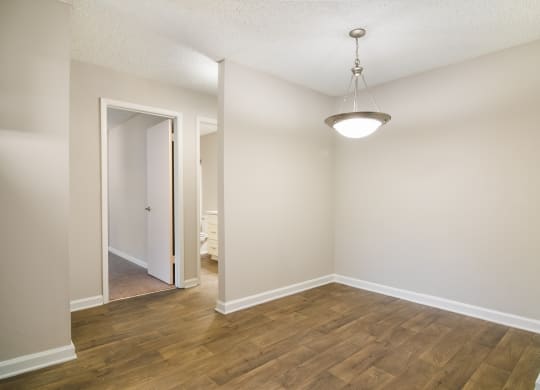 a bedroom with hardwood floors and white walls at Dunwoody Pointe in Sandy Springs, GA