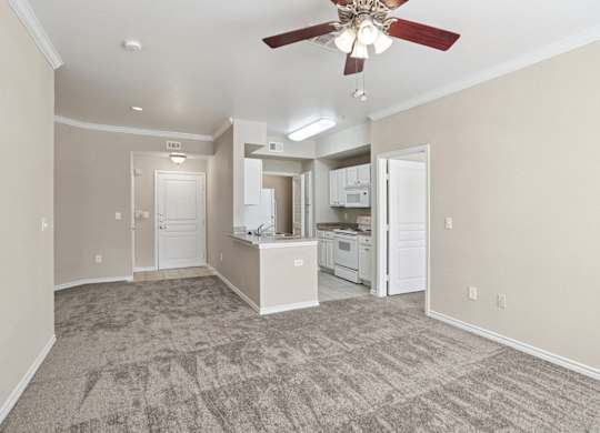 Edinburgh living room with carpet and a ceiling fan at Encore at Buckingham Apartments in Richardson, TX
