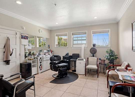 A hair salon with styling stations at Encore at Buckingham Apartments in Richardson, TX