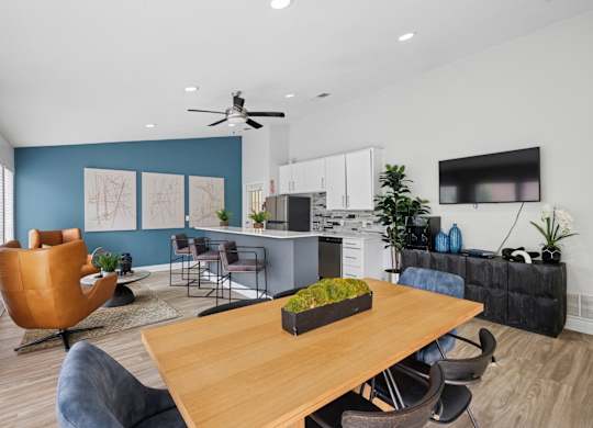 A modern kitchen with a dining table and chairs.