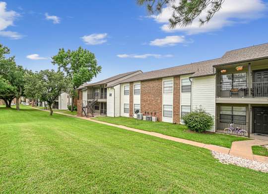 A sunny day at a residential area with houses and green lawns.
