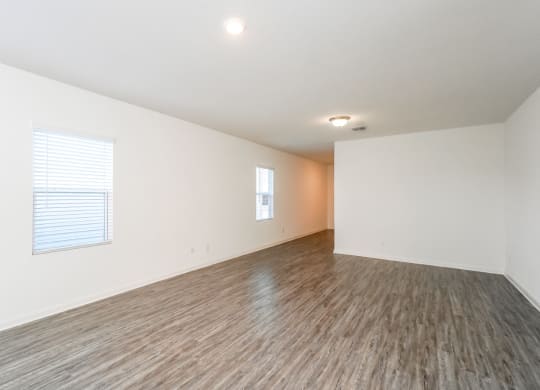 a bedroom with hardwood floors and white walls at Beacon at Meridian, Texas, 78245