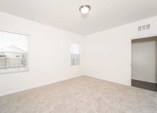 a bedroom with white walls and carpet
