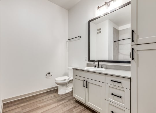 a bathroom with white appliances at Era Apartment in Denton, TX