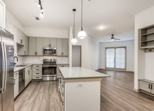 Spacious kitchen with kitchen island in 2 bedroom apartment at Era Apartment in Denton, TX