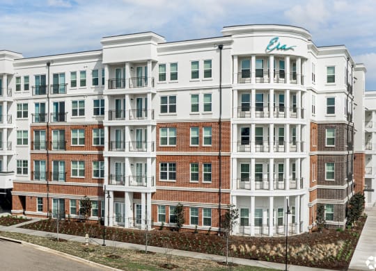 Side view with parking garage entryway of Era apartments in Denton, TX