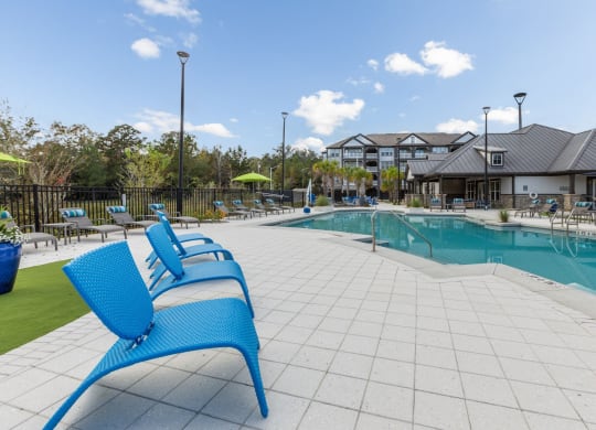Poolside seating in sunny days at Evergreen at Southwood in Tallahassee, FL