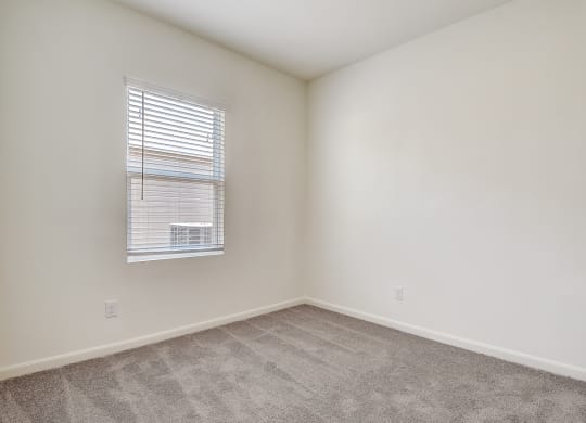 a bedroom with white walls and carpet at Beacon at Meridian, Texas