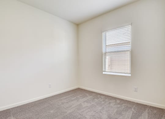 a bedroom with white walls and carpet at Beacon at Meridian, San Antonio