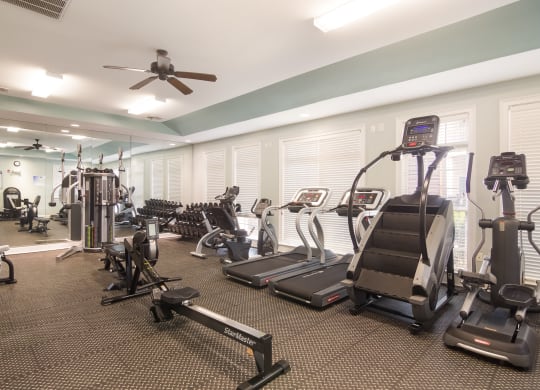 Fully equipped gym with modern workout machines at Angel Landing apartments in Pensacola, FL