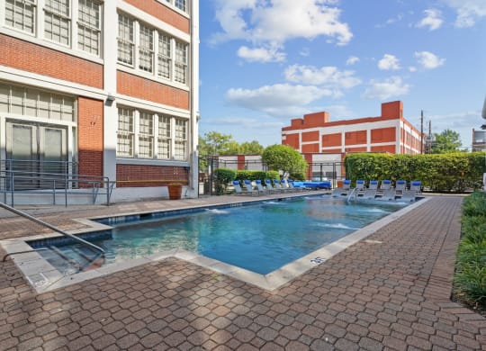 a swimming pool with a building in the background