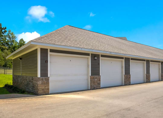 a row of garages with a blue sky in the background