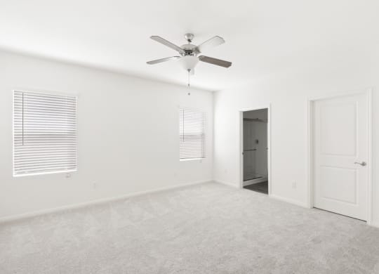 a bedroom with white walls and a ceiling fan  at Beacon at Bunton Creek, Kyle, TX 78640