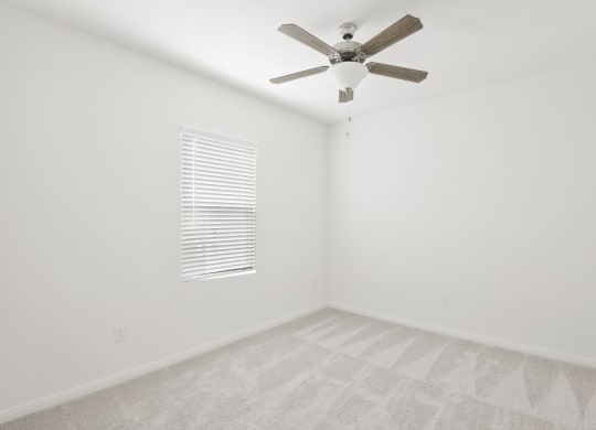 a bedroom with white walls and a ceiling fan at Beacon at Bunton Creek, Texas, 78640