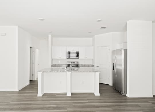 a kitchen with white cabinets and stainless steel appliances at Beacon at Meridian, Texas