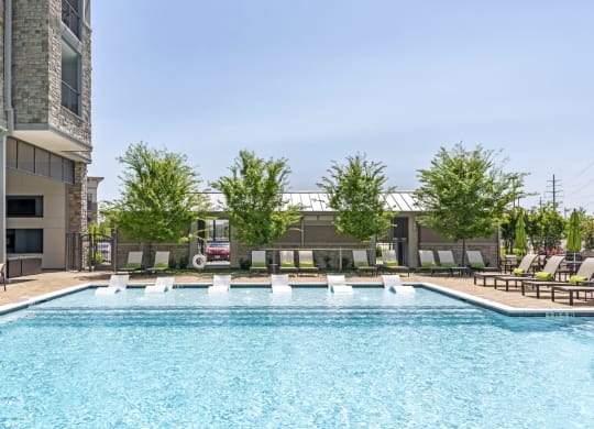 a swimming pool with lounge chairs of GreenVue in Richardson, TX