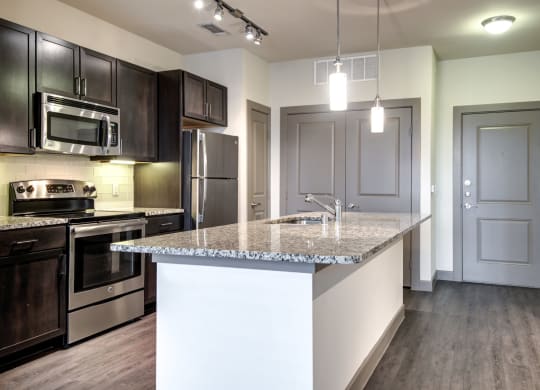 a kitchen with stainless steel appliances and a granite counter top