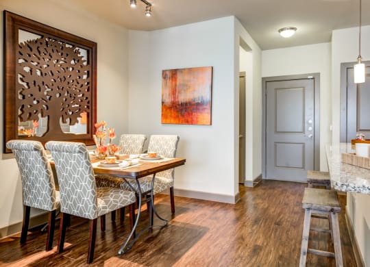 a dining room with a wooden table and chairs