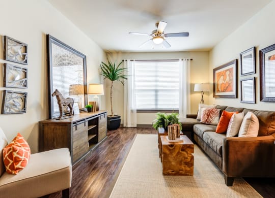 a living room with a couch and a ceiling fan