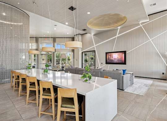 Clubhouse kitchen with island and a couch at GreenVue apartments in Richardson, TX